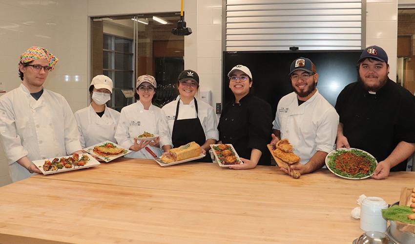 Picture of the Culinary Arts students showing their dishes.